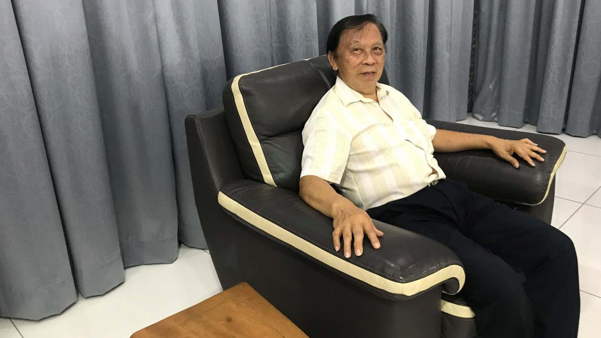 Hock Chye sitting in an arm chair.