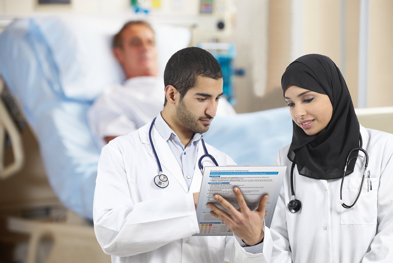 Saudi arab doctors diagnosing looking a medical history