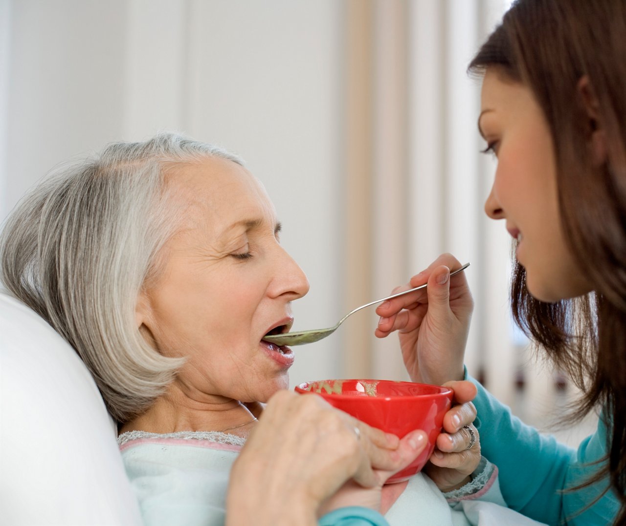 Woman feeding patient