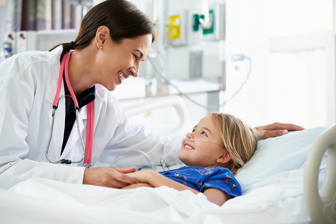 Female doctor and child (girl) - hospital setting