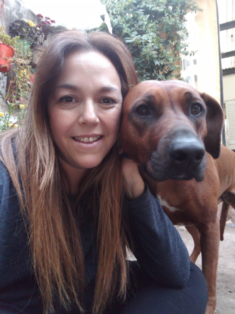 Maria taking a selfie with her dog.