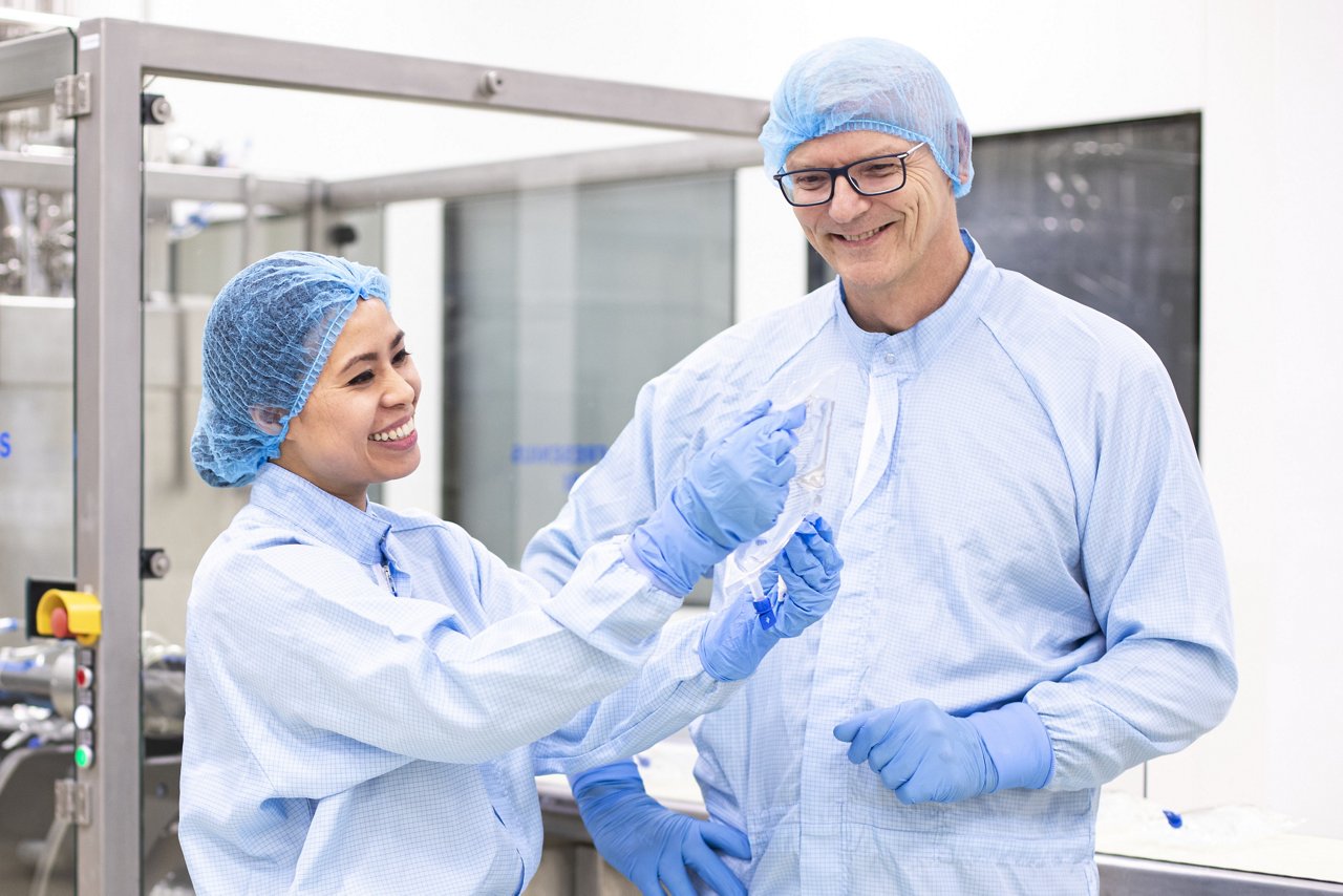 Fresenius Kabi lab technicians are examining an IV bag.
