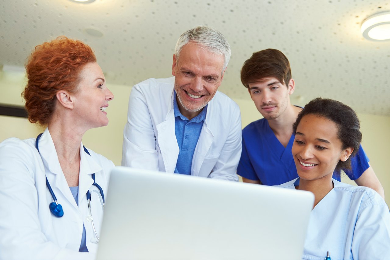 Doctors and nurses in front of laptop