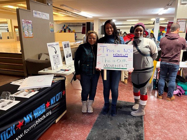 A group of women holding a sign