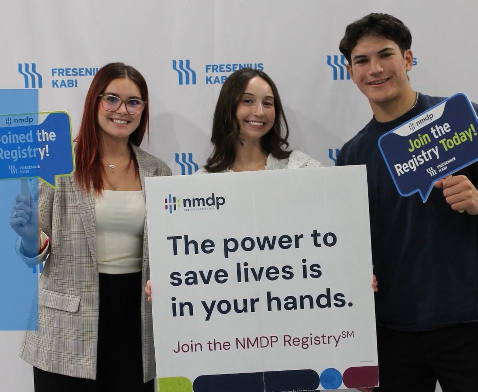 interns holding sign saying the power to save lives is in your hands. Join the NMDP registry.