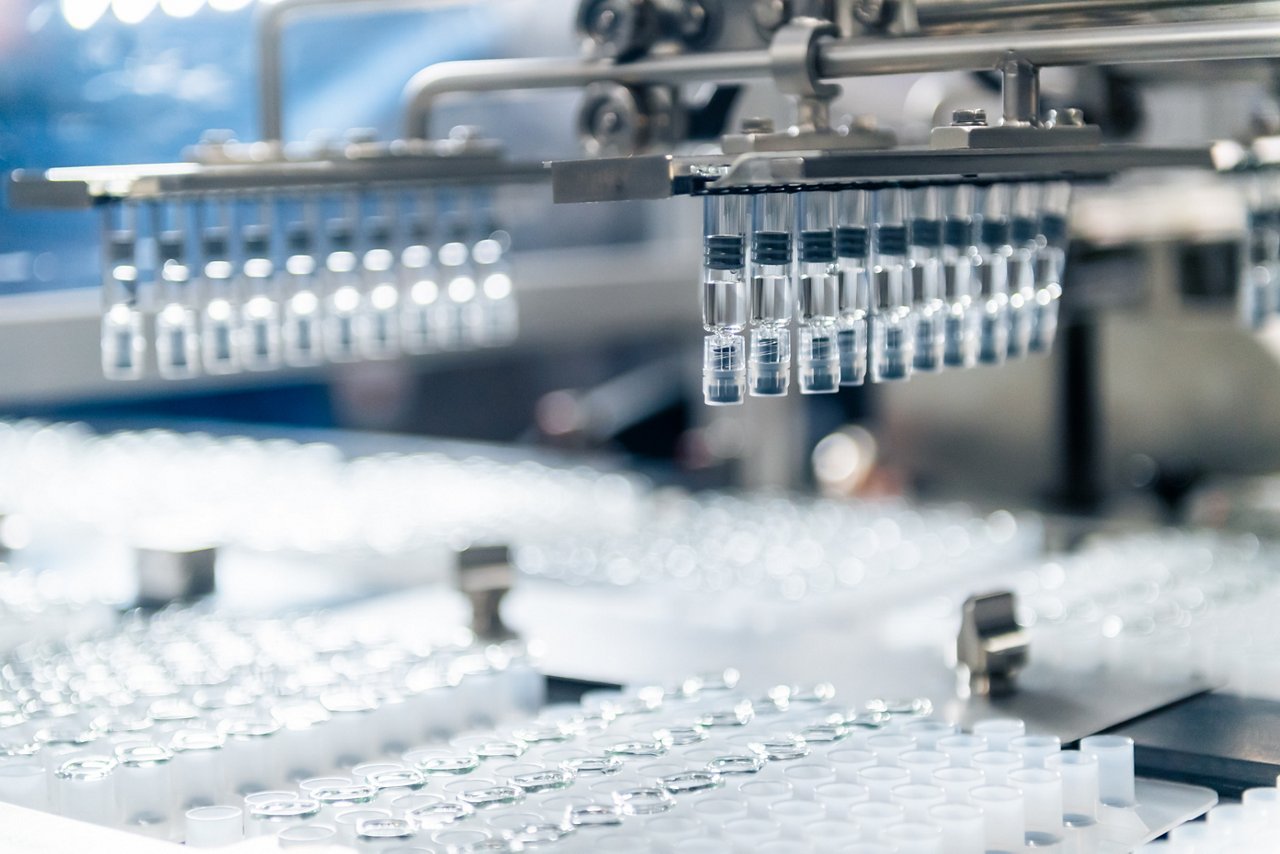 Cose up of automatic syringe manufacturing machine.