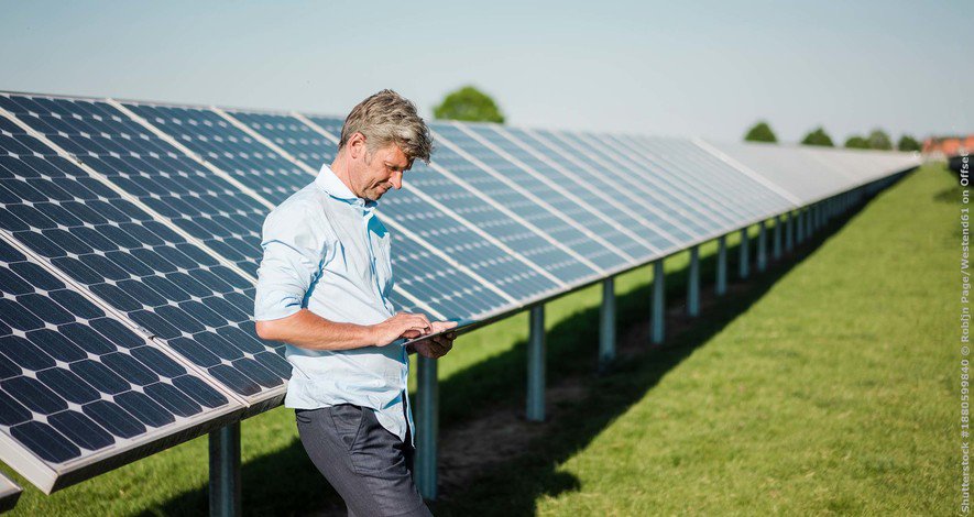 Businessman using tablet at solar park