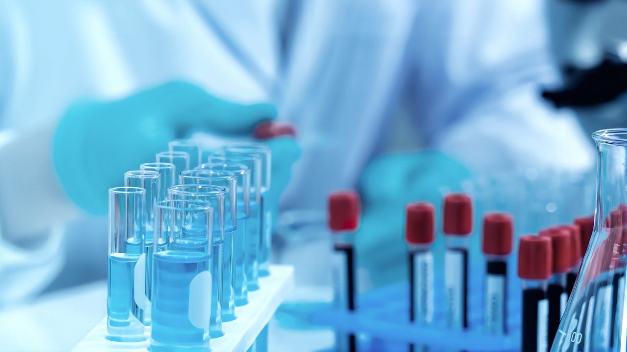 scientist in lab working with test tubes