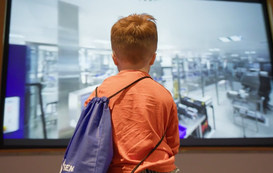 employee's child watching video of manufacturing plant 