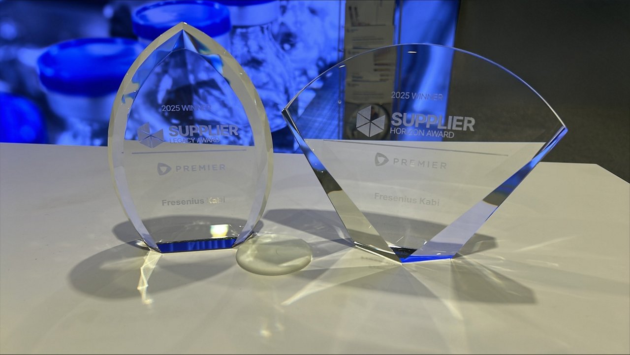 Two glass trophies engraved with '2025 Winner Supplier Horizon Award' and 'Premier Fresenius Kabi' displayed on a white table