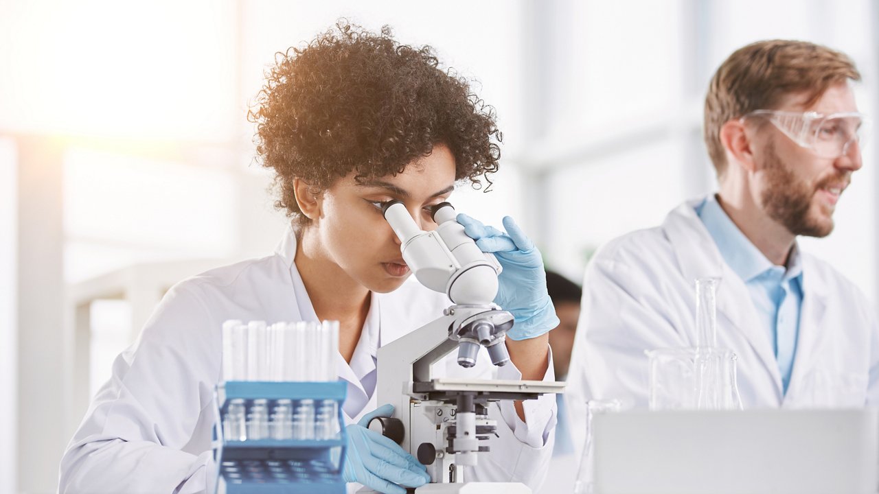 close-up. female scientist looking through a microscope. medical research concept.