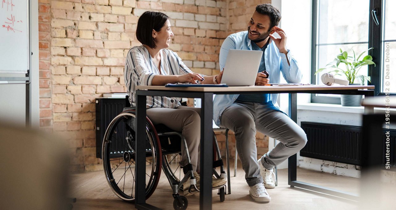 man and woman on wheelchair in the office