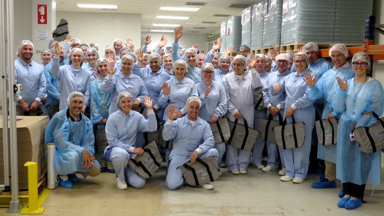 Group photo of Fresenius Kabi staff in protective clothing at antibiotic production facility in Portugal                 