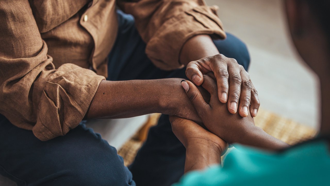 Closeup of a support hands. Closeup shot of a young woman holding a senior man's hands in comfort. Female carer holding hands of senior man 