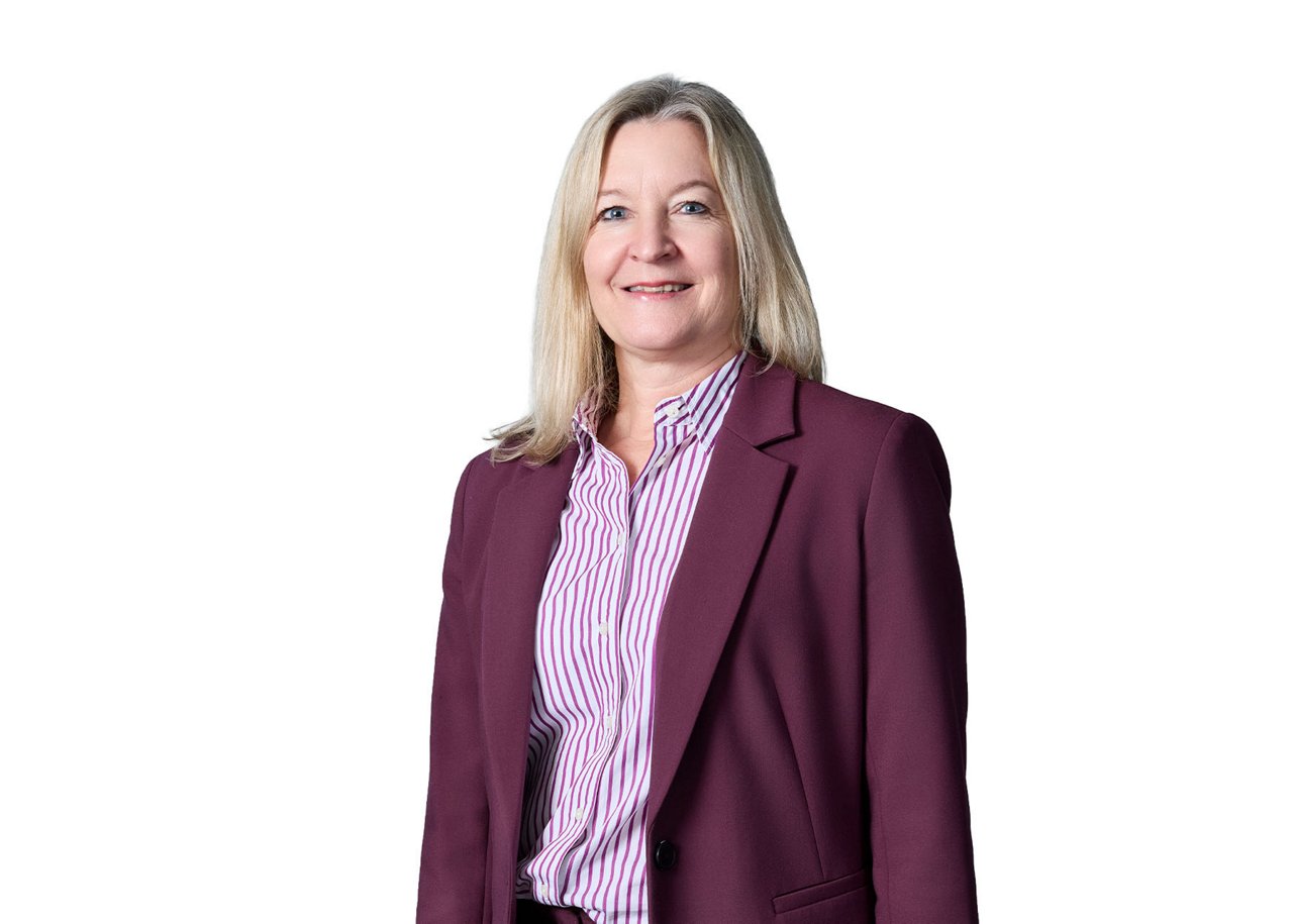 Corporate portrait of Tanja Greve, Executive Vice President, CFO Biopharma, wearing a burgundy blazer over a striped shirt against a white background.