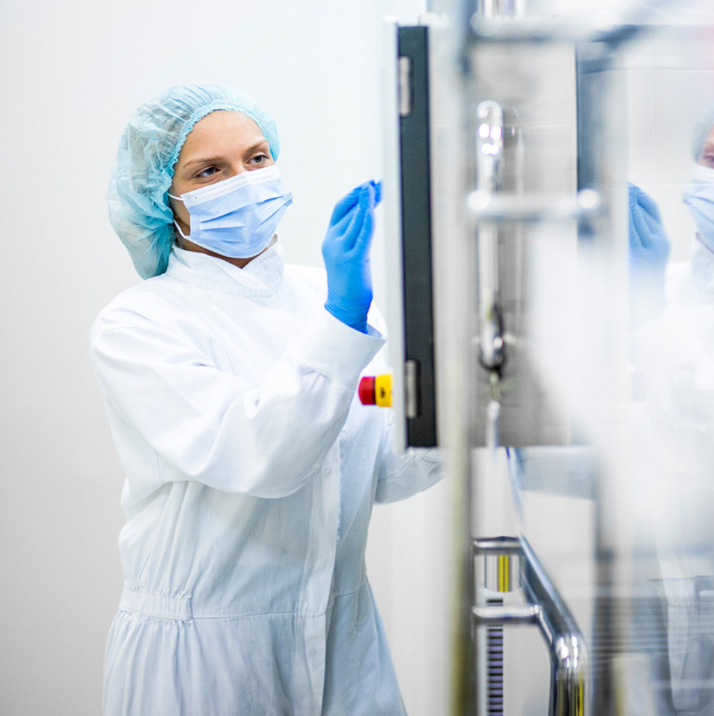 Technician with scrubs at screen